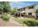 Spacious backyard with a covered patio, perfect for outdoor dining and relaxing, surrounded by lush greenery at 6251 W 74Th Ave, Arvada, CO 80003