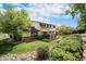 Spacious backyard with a covered patio, lush landscaping, and a well-maintained lawn at 6251 W 74Th Ave, Arvada, CO 80003