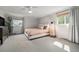 Bright bedroom featuring neutral tones, plush carpet, and large windows at 6251 W 74Th Ave, Arvada, CO 80003