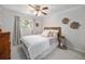 Cozy bedroom with ceiling fan, window, and decorative elements provides a warm and inviting space at 6251 W 74Th Ave, Arvada, CO 80003