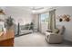 Serene Bedroom with a pale blue crib, comfortable recliner, and soft pastel arched design, perfect for a peaceful retreat at 6251 W 74Th Ave, Arvada, CO 80003