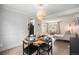 Cozy dining room with a round table, stylish light fixture, and seamless flow to the living area at 6251 W 74Th Ave, Arvada, CO 80003