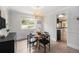 Charming dining room features a round table, modern light fixture, and bright window at 6251 W 74Th Ave, Arvada, CO 80003