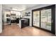 Bright kitchen boasts white brick walls, stainless steel appliances, and access to the patio at 6251 W 74Th Ave, Arvada, CO 80003