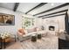 Comfortable living room featuring a cozy fireplace, large window, and inviting sectional sofa, perfect for Gathering gatherings at 6251 W 74Th Ave, Arvada, CO 80003