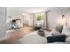 Inviting living room featuring a cozy sectional sofa, wood floors, and natural light from a large window, perfect for relaxation at 6251 W 74Th Ave, Arvada, CO 80003
