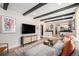 Modern living room with a cozy sofa, stylish decor, and an open layout leading to the kitchen at 6251 W 74Th Ave, Arvada, CO 80003