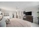 Spacious main bedroom features ample natural light, a ceiling fan, and ensuite bathroom access at 6251 W 74Th Ave, Arvada, CO 80003