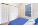 Cozy bedroom featuring a window with a blue exterior view, and a sliding door closet at 2350 N Ogden St, Denver, CO 80205