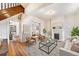 Bright living room with hardwood floors, fireplace, and an open layout leading to the dining area at 2350 N Ogden St, Denver, CO 80205