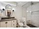 Basement bathroom with walk-in shower, gray vanity, and toilet at 3481 Meadow Creek Pl, Highlands Ranch, CO 80126