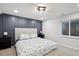 Basement bedroom with gray accent wall and floral bedding at 3481 Meadow Creek Pl, Highlands Ranch, CO 80126