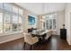 Elegant dining room with hardwood floors and large windows at 3481 Meadow Creek Pl, Highlands Ranch, CO 80126