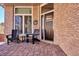 Brick front porch with seating and a welcoming entryway at 3481 Meadow Creek Pl, Highlands Ranch, CO 80126