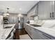 Modern kitchen with gray cabinets, marble countertops, and stainless steel appliances at 3481 Meadow Creek Pl, Highlands Ranch, CO 80126