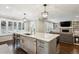 Open concept kitchen features marble countertops, island seating, and stainless steel appliances at 3481 Meadow Creek Pl, Highlands Ranch, CO 80126