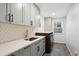 Laundry room with modern cabinets and sink at 3481 Meadow Creek Pl, Highlands Ranch, CO 80126