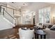 Open and airy living room with hardwood floors and large windows at 3481 Meadow Creek Pl, Highlands Ranch, CO 80126