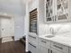 Stylish wet bar with wine cooler and marble countertops at 3481 Meadow Creek Pl, Highlands Ranch, CO 80126