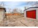 Backyard showcasing mature trees, a detached garage, and a partially fenced-in area at 2056 Fulton St, Aurora, CO 80010