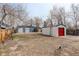 Backyard includes mature trees, a storage shed, and a detached garage at 2056 Fulton St, Aurora, CO 80010