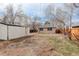 View of the backyard showcasing the detached garage, storage shed, and mature trees at 2056 Fulton St, Aurora, CO 80010
