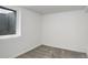 Bright basement bedroom with a window well and neutral carpeting at 2056 Fulton St, Aurora, CO 80010