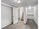 Basement features gray carpet, stairs, and a built-in closet at 2056 Fulton St, Aurora, CO 80010