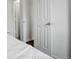 Bedroom featuring a neatly made bed, neutral color palette, and a glimpse into an adjacent room at 2056 Fulton St, Aurora, CO 80010