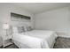 Comfortable bedroom with neutral tones, featuring a queen-sized bed, modern decor, and carpeted floors at 2056 Fulton St, Aurora, CO 80010