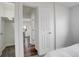 Bright bedroom with a glimpse into the hallway and closet, showcasing carpeted floors and neutral walls at 2056 Fulton St, Aurora, CO 80010