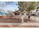 Charming single-story home with a fenced front yard and a red front door at 2056 Fulton St, Aurora, CO 80010