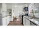 Modern kitchen with white cabinets, granite countertops, and stainless steel appliances at 2056 Fulton St, Aurora, CO 80010