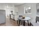 Bright kitchen featuring stainless steel appliances, white cabinets, and an adjacent breakfast nook with natural light at 2056 Fulton St, Aurora, CO 80010
