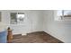 Bright living room with white walls, wood floors, and natural light from large windows at 2056 Fulton St, Aurora, CO 80010