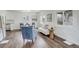Bright and airy living area with wood flooring and access to the dining space and kitchen at 2056 Fulton St, Aurora, CO 80010