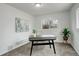 Bright and airy office space with a modern desk, chair, large window, and fresh green plants at 2056 Fulton St, Aurora, CO 80010