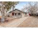 Exterior view of a single-story home with a spacious backyard and a detached garage at 2056 Fulton St, Aurora, CO 80010