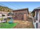 Cozy backyard with a patio, seating and a small garden with mountain views in the background at 230 Miner St, Idaho Springs, CO 80452