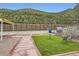 Manicured backyard with an artificial lawn, stone path and seating area at 230 Miner St, Idaho Springs, CO 80452