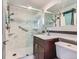 Bathroom featuring a walk-in shower with glass door and updated vanity at 230 Miner St, Idaho Springs, CO 80452