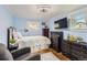 Comfortable bedroom with hardwood floors, a ceiling fan, and drawers under the bed at 230 Miner St, Idaho Springs, CO 80452