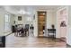 Open dining area featuring wood floors, a modern table, and a bathroom view at 230 Miner St, Idaho Springs, CO 80452