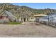 Exterior of a cute home with a carport and a low-maintenance gravel yard at 230 Miner St, Idaho Springs, CO 80452