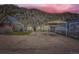 Inviting home exterior with a carport set against a scenic mountain backdrop at dusk at 230 Miner St, Idaho Springs, CO 80452