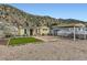 Quaint yellow home exterior with a convenient carport and low-maintenance gravel yard at 230 Miner St, Idaho Springs, CO 80452