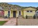 Close up of quaint home with stone pathway and a cozy front porch bench at 230 Miner St, Idaho Springs, CO 80452