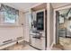 Kitchen area with stainless steel refrigerator and access to the outside and other rooms at 230 Miner St, Idaho Springs, CO 80452