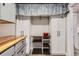 Well-organized laundry room features built-in cabinets and convenient folding area with shelves at 230 Miner St, Idaho Springs, CO 80452