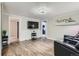 Cozy living room featuring wood-look floors, a TV, and comfortable seating at 230 Miner St, Idaho Springs, CO 80452